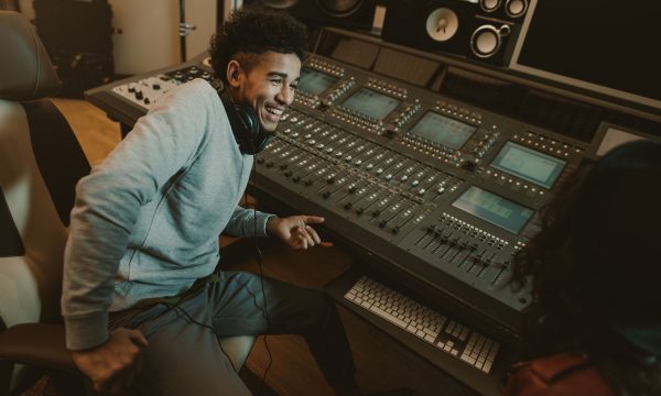 happy young sound producer sitting at studio happy young sound producer sitting at studio